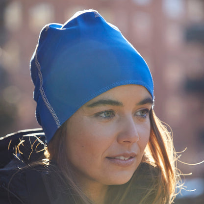 Woman wearing a blue beanie with a blurred background