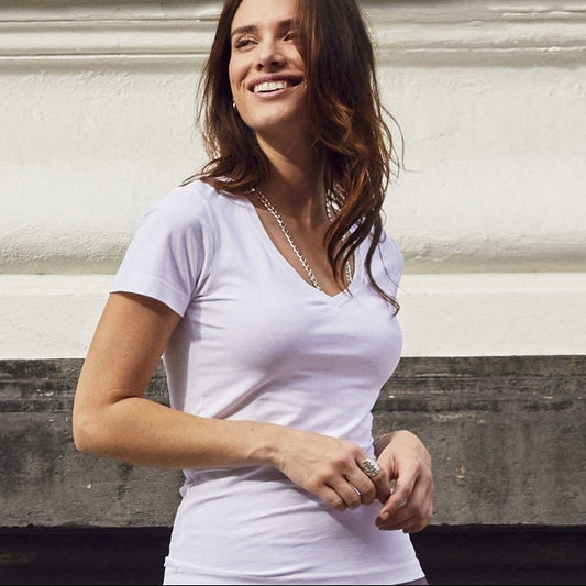 Woman standing on a street with a building in the background