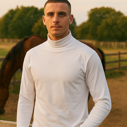 Man wearing a white turtleneck sweater standing in front of a horse in an outdoor setting.